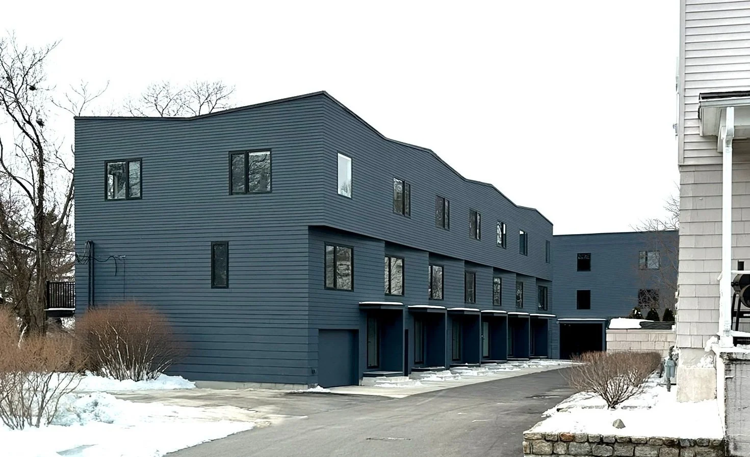Rear view of Matilda Overlook townhomes with undulating roofline on the hillside