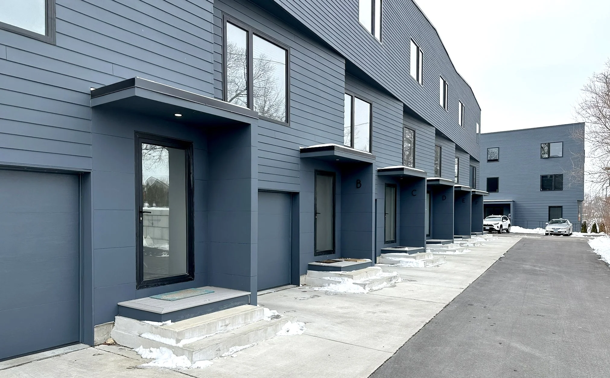 Matilda Overlook townhome row showing individual stoops and undulating roofline at 47 Matilda Street, Providence RI
